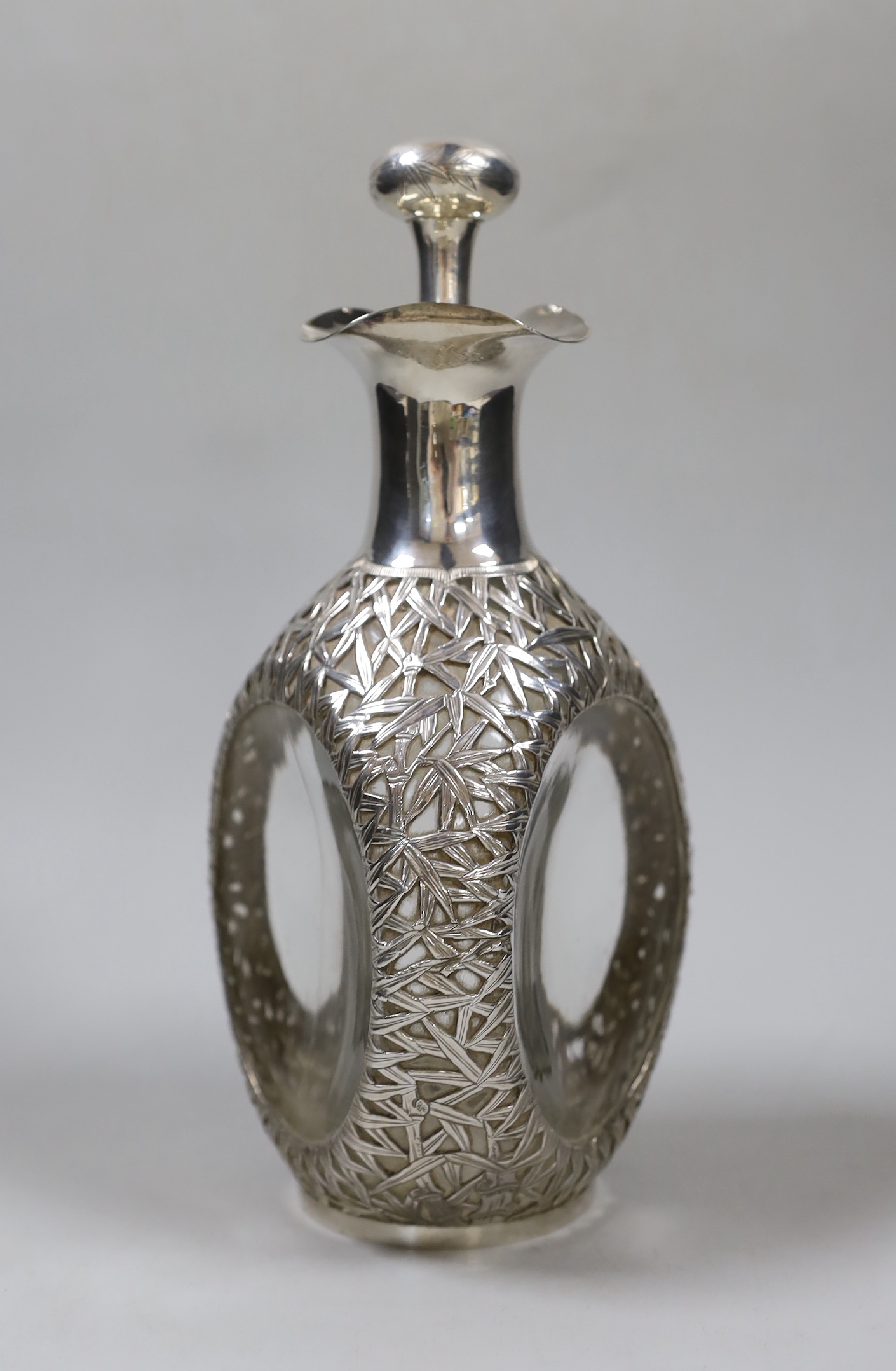 An early 20th century Chinese white metal mounted glass Haig decanter and stopper, Hong Kong, height 26.3cm.